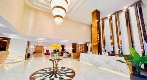 a lobby with a table in the middle of a building at Midland Hotel in Phnom Penh