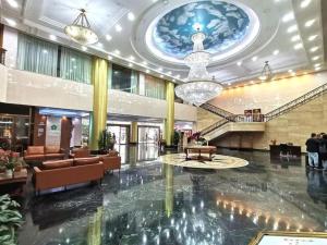 a lobby of a hotel with a chandelier at Golden Lustre Hotel in Hong Kong +167 photos