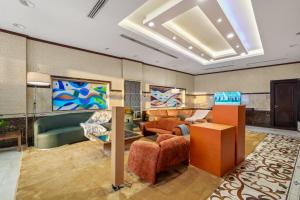 a living room with couches and chairs in a room at Grand Residence in Riyadh