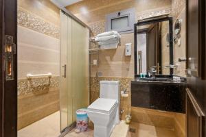 a bathroom with a toilet and a sink at Grand Residence in Riyadh +11 photos