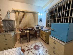 a kitchen with a table and a stove top oven at Departamento Nuevo Céntrico Las Marías 1 in Saltillo +31 photos