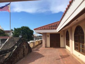 a flag flying in front of a building at The Premiere Business Hotel in Kalibo