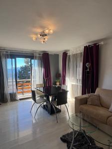 a living room with a table and a couch at Grand 2 pièces ensoleillé in Font-Romeu