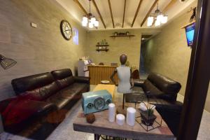 a living room with a couch and a table with a statue at Mumu Inn in Hengchun South Gate