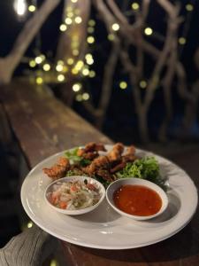 a plate with two bowls of food on a table at Sea PoeTree in Koh Rong Sanloem