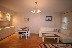 a living room with a couch and a table at Apartament Bryza in Jurata