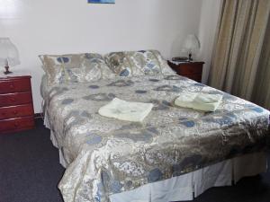 A bed or beds in a room at Arthur River Holiday Units