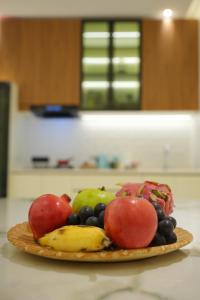 a plate of fruit sitting on a table at 6 BHK Serviced Apartment beside Kolencherry MOSC Hospital in Kadayirippu