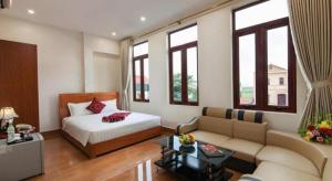 a bedroom with a bed and a couch in a room at Luxury Airport Hotel & Spa in Phu Lo Dong +147 photos