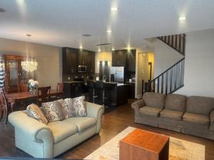 a living room with a couch and a kitchen at Panorama Haven in Calgary