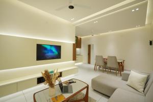 a living room with a couch and a table at 6 BHK Serviced Apartment beside Kolencherry MOSC Hospital in Kadayirippu