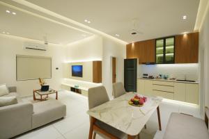 a living room with a couch and a table at 6 BHK Serviced Apartment beside Kolencherry MOSC Hospital in Kadayirippu