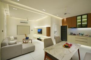 a living room with a couch and a table at 6 BHK Serviced Apartment beside Kolencherry MOSC Hospital in Kadayirippu +31 photos