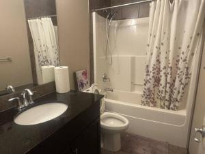 a bathroom with a sink and a toilet and a shower at Panorama Haven in Calgary