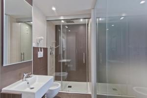 a bathroom with a glass shower and a sink at Biafora Resort & Spa in San Giovanni in Fiore