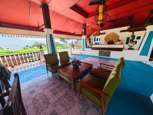 a living room with a table and chairs at The Moon Rabbit Resort Pai in Pai