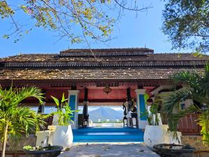 a villa with a pool in front of a house at The Moon Rabbit Resort Pai in Pai