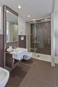 a bathroom with two sinks and a shower at Biafora Resort & Spa in San Giovanni in Fiore