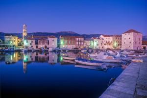 a group of boats in a harbor at night at Barać in Kaštela