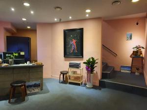 a waiting room with a woman painting on the wall at Daljee Guesthouse in Seoul
