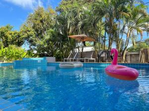 a swimming pool with a pink rubber duck in the water at Serenity by Peace Garden in Amphoe Koh Samui