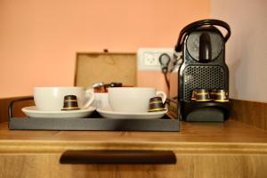 two cups and saucers sitting on top of a counter at Azura Boutique Hotel Tiberias in Tiberias