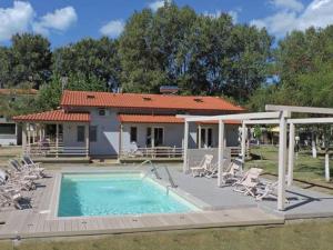 a house with a swimming pool and chairs and a house at Camping Valti Houses in Sarti +21 photos