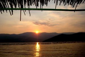 a view of the sun setting over the water at Sunrise Apartments and Studios in Star Dojran