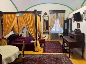 a bedroom with a canopy bed and a piano at Royal Transylvanian Castle - near Banffi in Gherla +31 photos