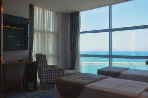 a hotel room with two beds and a view of the ocean at Panorama Damla Otel in Samsun