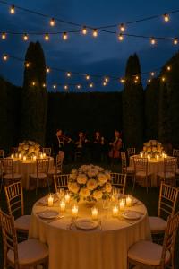 a group of tables with candles and flowers and lights at Royal Transylvanian Castle - near Banffi in Gherla