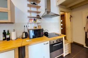 a kitchen with a counter with a microwave and a stove at Corvin Museum View Studio in Budapest