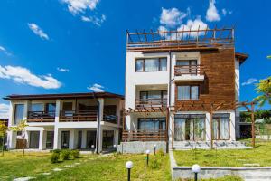 an apartment building with a balcony on top of it at Guest House Ognyanovo in Ognyanovo