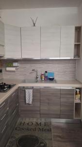 a kitchen with white cabinets and a sink at GS Valtellina in Morbegno