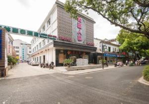 a street corner with a store on a city street at GreenTree Inn Suzhou Guanqian Yangyuxiang Metro Station Business Hotel in Suzhou