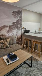 a living room with a couch and a table at Critchley Hackle - Deluxe garden units in Dullstroom