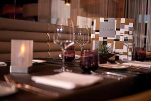 a table with wine glasses and plates on it at INNSiDE by Meliá Düsseldorf Hafen in Düsseldorf +44 photos