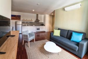 a living room with a couch and a table at Anchieta 60 in Las Lagunas