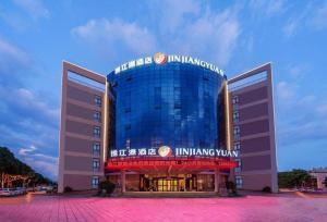 a building with a sign on the front of it at Jinjiang Inn select Hotel Kunming Economic Development Zone Kunming College in Kunming