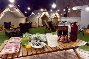 a picnic table with food and drinks and tents at 3S HOTEL ANYANG 1st FASHION in Anyang