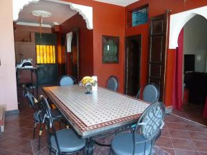 a dining room with a table and some chairs at Villa La Zitoune in Aghmat
