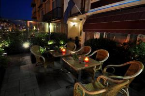 a table and chairs on a patio at night at Pension & Spa de Watertoren in Zandvoort