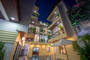 a building with balconies and an umbrella at Hoi An Paradise Villa in Hoi An