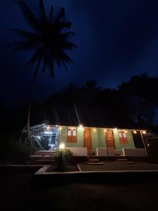 a house with lights on it at night at ViAN Mistyrocks in Mamalakandam