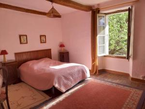 a bedroom with a bed and a window at Maison Authentique en Ubaye in Jausiers +7 photos