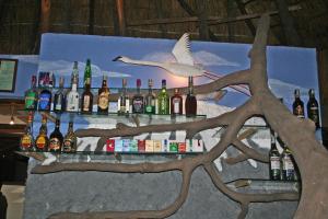 a bar with bottles of alcohol on a wall at Roika Tarangire Tented Lodge in Kwa Kuchinia