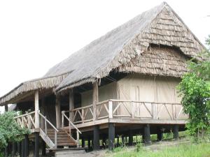 a large hut with a thatched roof and a staircase at Roika Tarangire Tented Lodge in Kwa Kuchinia