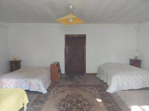 a bedroom with two beds and a ceiling at Maison Authentique en Ubaye in Jausiers