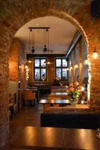 an archway in a restaurant with tables and chairs at Liberum Residence Old Town in Gdańsk