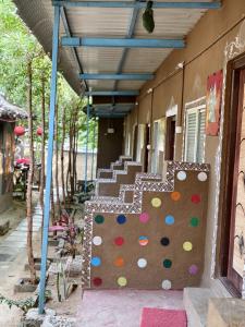 a building with a rock wall on the side of it at Jungle Tree Hampi in Hampi